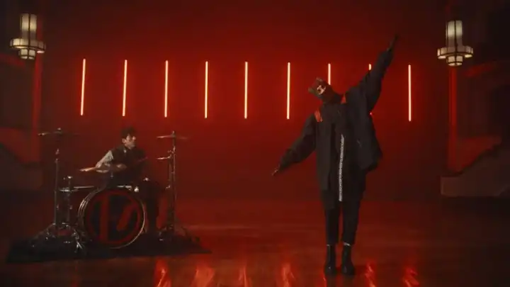 Twenty One Pilots returns with new single Overcompensate. Watch the music video with lyrics!